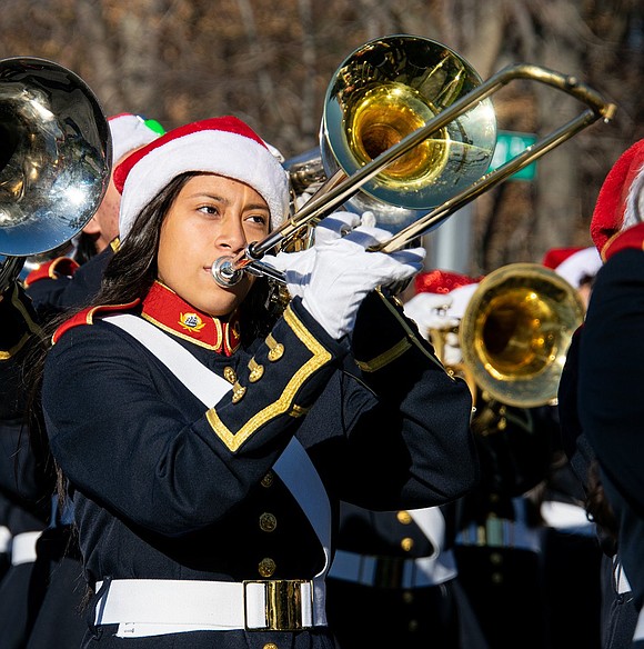 Lesly Tenecela, a freshman, accompanies the Pride of Port Chester on the trombone as they play holiday music during the annual Christmas Parade.