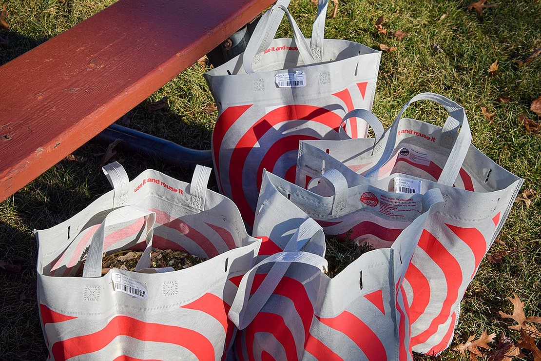 Mulch fills reusable Target bags that Port Chester Sustainability Committee Co-Chairs Ann Giannantonio and Brandon Hermoza-Ricci brought to the event. They were available to any families who didn’t bring containers of their own for collecting wood chips.