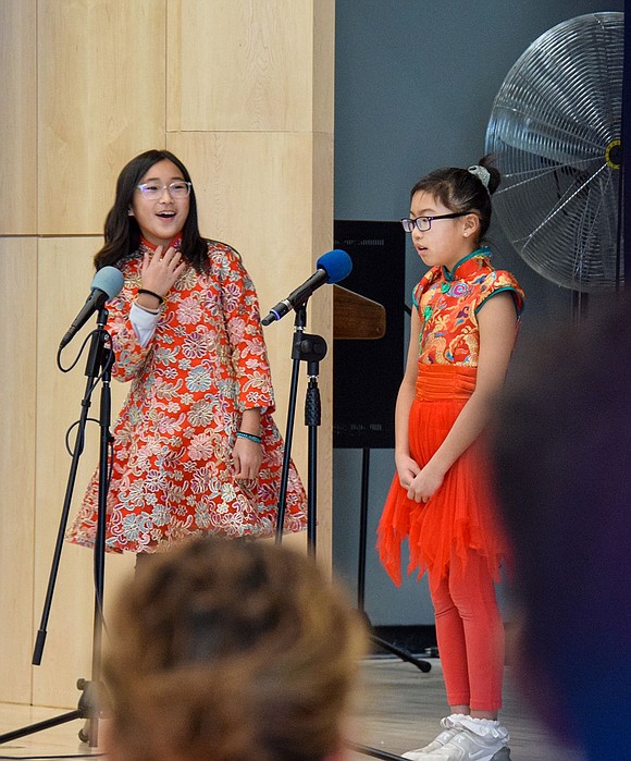 Grace Zhu (left) and Grace Miao, both fourth-graders, present at the assembly, discussing the aspects of the Lunar New Year tradition practiced by their families’ cultures. This year, the holiday fell on Sunday, Jan. 22.