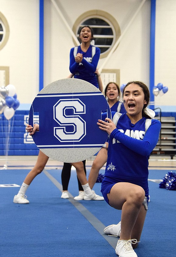 Port Chester is home of the RAMS! Modified cheer team eighth-grader Erandi Flores holds up an “S” sign to help spell out the name while elevated eighth-grader Sophia Bautista chants from behind her.