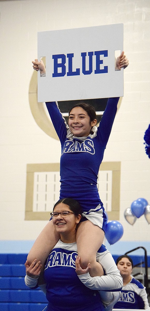 A proud and mighty Ram, junior varsity freshman Amy Navas holds up a sign reading one of the school’s colors while sitting on freshman Mariangel Osorio’s shoulders.