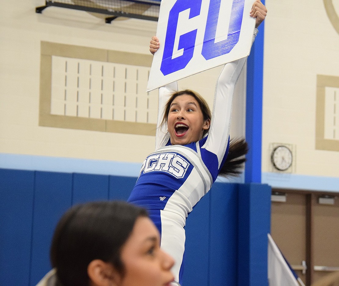 Port Chester High School freshman Melina Morbin’s face says it all as she enthusiastically thrusts up a “go” sign to amp up the crowd during the varsity team’s routine.