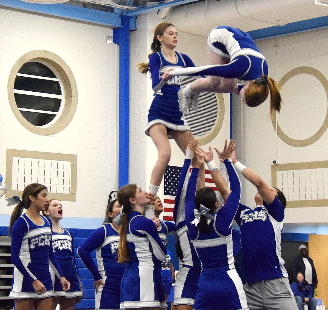 In a skilled stunt, varsity senior Sophia Quartarolo takes a hoisted position as she supports freshman Kelly Pascale in doing a flip.