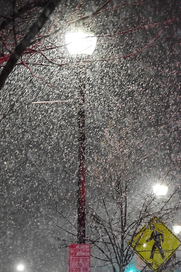 Snow falls steadily as illuminated by a streetlight on North Main Street Monday night, Feb. 27.