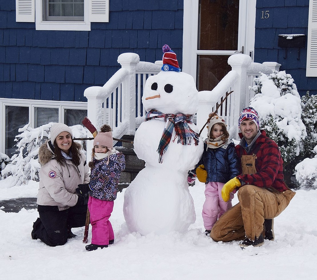 Ashley, 2-year-old Charlotte, 4-year-old Brooke and James Synowiez gather round their freshly made snowman in front of their house at 15 Burdsall Dr. Tuesday morning, Feb. 28, after the first snowstorm of the season dropped about three inches of snow in Port Chester and Rye Brook overnight.